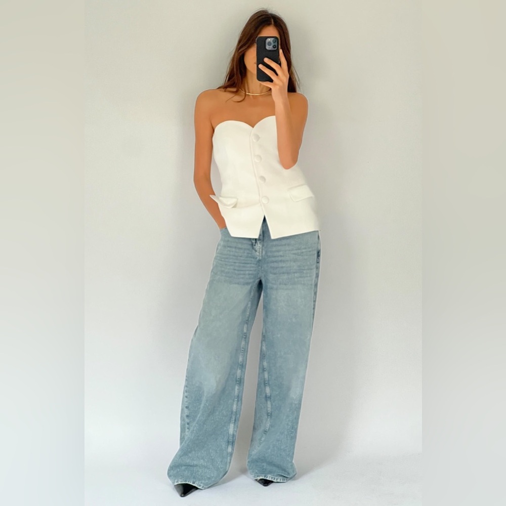 Oyster White Strapless straight neck bustier. Satin effect flaps at front.